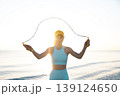 Fit woman jumping rope at the beach during summer vacation 139124650