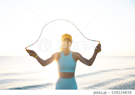 Fit woman jumping rope at the beach during summer vacation 139124650