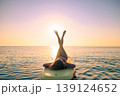 Young woman walking on sup board by the sea during summer vacation 139124652