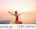 Young woman walking on sup board by the sea during summer vacation 139124654