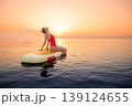 Young woman walking on sup board by the sea during summer vacation 139124655