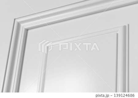 Close-up view of a white interior door panel showing decorative molding 139124686