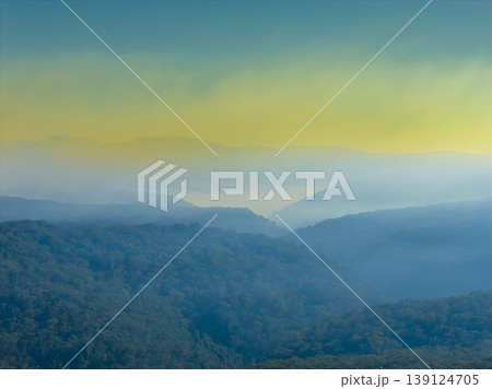 Smoke from hazard reduction burning in a valley at sunrise in the Blue Mountains 139124705