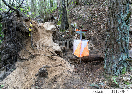 Orienteering control point with orange and white flag Orienteering control point with orange and white flag 139124904