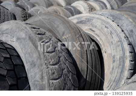 Pile of used car tires ready for recycling. Stacked old tires in a recycling yard. Pile of used car tires ready for recycling. Stacked old tires in a recycling yard. 139125935