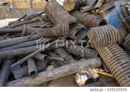Used PVC Pipes Thrown Away at Scrap Site. Discarded Construction Pipes at Recycling Area. 139125939