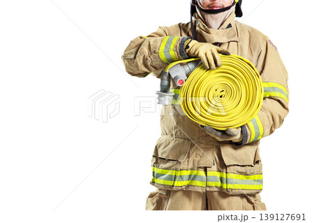 Firefighter in protective uniform holding a fire hose roll 139127691