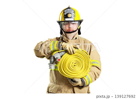 Firefighter in protective uniform holding a fire hose roll Firefighter in protective uniform holding a fire hose roll 139127692