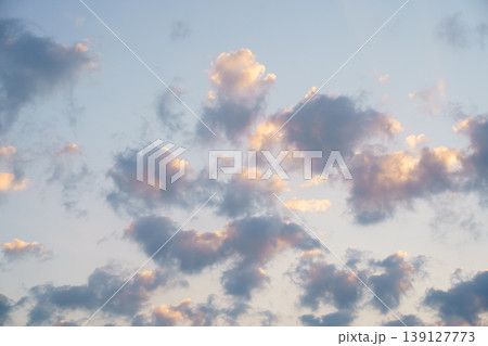 Beautiful sunset sky with soft fluffy clouds in golden hour 139127773