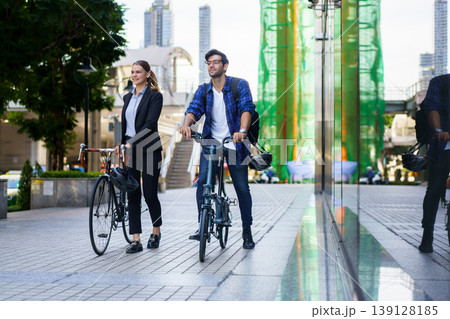 Business people with bicycles walking in urban environment. Business people with bicycles walking in urban environment. 139128185