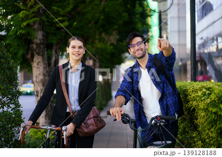 Business people with bicycles walking in urban environment. Business people with bicycles walking in urban environment. 139128188