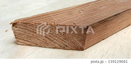 Close-up image of a wooden block with natural grain. Close-up image of a wooden block with natural grain. 139129081
