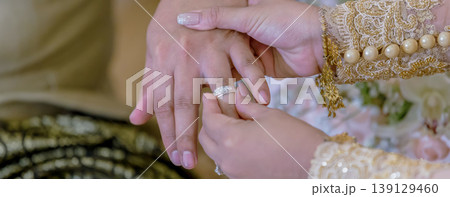 Groom show wedding ring on the box before give to bride in wedding ceremony. Groom show wedding ring on the box before give to bride in wedding ceremony. 139129460