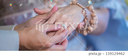 Groom show wedding ring on the box before give to bride in wedding ceremony. Groom show wedding ring on the box before give to bride in wedding ceremony. 139129462