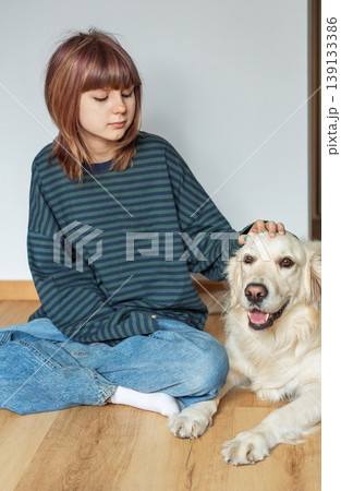 Young woman bonding with golden retriever dog at home Young woman bonding with golden retriever dog at home 139133386