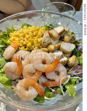 Fresh salad with a mix of crisp leafy greens, sliced vegetables, and colorful ingredients, tossed together to create a healthy, vibrant, and refreshing dish full of natural flavors Fresh salad with a mix of crisp leafy greens, sliced vegetables, and colorful ingredients, tossed together to create a healthy, vibrant, and refreshing dish full of natural flavors 139134209