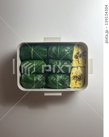 Bento or dosirak box filled with rice, assorted side dishes, vegetables, and protein like meat or fish, all neatly arranged to create a balanced, colorful, and visually appealing meal 139134304
