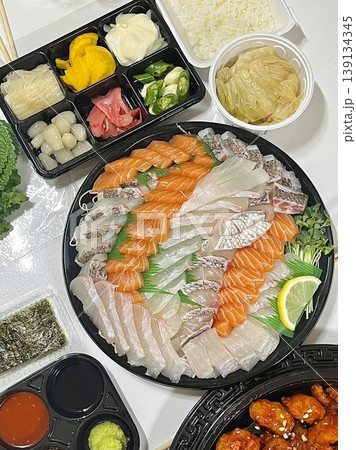 Fresh and delicate sashimi slices, beautifully presented with vibrant colors and perfect cuts. This traditional Japanese delicacy highlights the pure flavors of premium seafood. 139134345