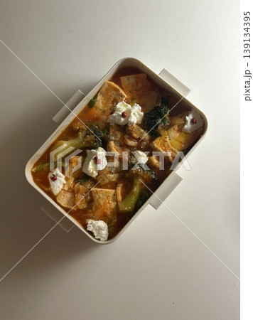 Bento or dosirak box filled with rice, assorted side dishes, vegetables, and protein like meat or fish, all neatly arranged to create a balanced, colorful, and visually appealing meal 139134395