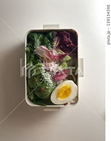 Bento or dosirak box filled with rice, assorted side dishes, vegetables, and protein like meat or fish, all neatly arranged to create a balanced, colorful, and visually appealing meal 139134398