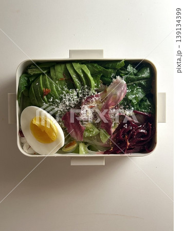 Bento or dosirak box filled with rice, assorted side dishes, vegetables, and protein like meat or fish, all neatly arranged to create a balanced, colorful, and visually appealing meal Bento or dosirak box filled with rice, assorted side dishes, vegetables, and protein like meat or fish, all neatly arranged to create a balanced, colorful, and visually appealing meal 139134399