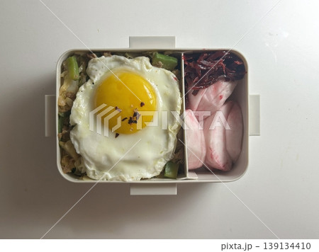 Bento or dosirak box filled with rice, assorted side dishes, vegetables, and protein like meat or fish, all neatly arranged to create a balanced, colorful, and visually appealing meal Bento or dosirak box filled with rice, assorted side dishes, vegetables, and protein like meat or fish, all neatly arranged to create a balanced, colorful, and visually appealing meal 139134410