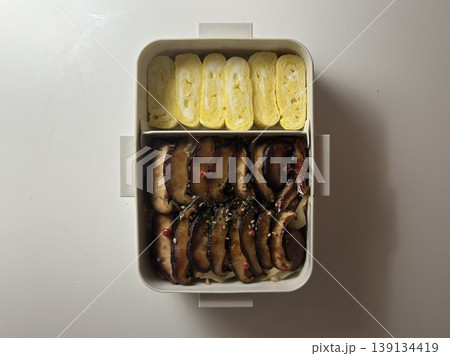 Bento or dosirak box filled with rice, assorted side dishes, vegetables, and protein like meat or fish, all neatly arranged to create a balanced, colorful, and visually appealing meal Bento or dosirak box filled with rice, assorted side dishes, vegetables, and protein like meat or fish, all neatly arranged to create a balanced, colorful, and visually appealing meal 139134419