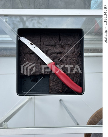 Rich, gooey fudge brownies with a dense, chocolatey center and a perfectly crisp top. Ideal for chocolate lovers craving a satisfying, indulgent treat. 139134597