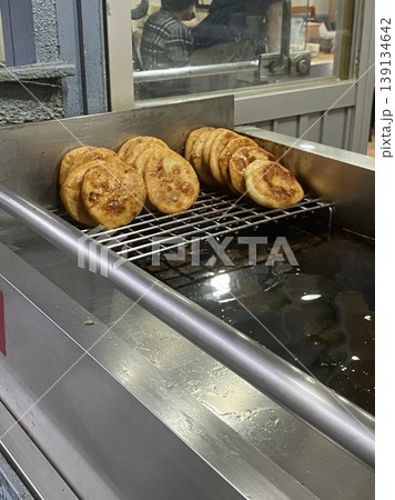 Golden, crispy Hotteok, a popular Korean street snack filled with gooey, sweet syrup, brown sugar, and nuts. Perfectly warm and satisfying with each chewy bite. Golden, crispy Hotteok, a popular Korean street snack filled with gooey, sweet syrup, brown sugar, and nuts. Perfectly warm and satisfying with each chewy bite. 139134642