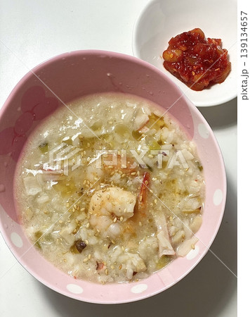 Warm and comforting juk (Korean rice porridge) with a smooth, velvety texture, offering a perfect blend of gentle flavor and nourishing simplicity in every soothing, satisfying spoonful. Warm and comforting juk (Korean rice porridge) with a smooth, velvety texture, offering a perfect blend of gentle flavor and nourishing simplicity in every soothing, satisfying spoonful. 139134657