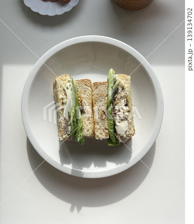 Delicious sandwich filled with fresh ingredients like crisp vegetables, tender meats, and savory spreads, all between two slices of soft bread. Perfect for a quick and satisfying meal. Delicious sandwich filled with fresh ingredients like crisp vegetables, tender meats, and savory spreads, all between two slices of soft bread. Perfect for a quick and satisfying meal. 139134702
