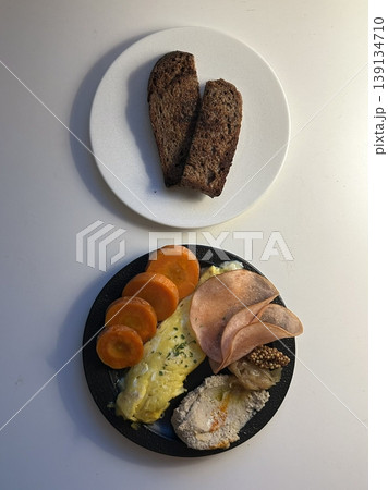 A delightful brunch spread featuring a mix of savory and sweet dishes, including fresh pastries, eggs, seasonal fruits, and a hot beverage. A perfect mid-morning indulgence. 139134710