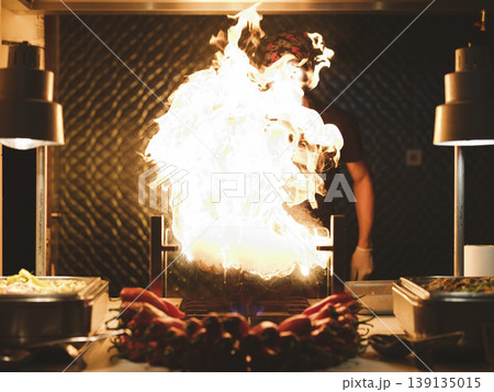 a chef cooking at a hotel buffet 139135015