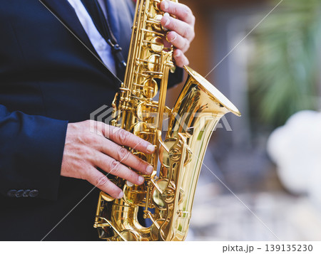 a man playing the saxophone a man playing the saxophone 139135230