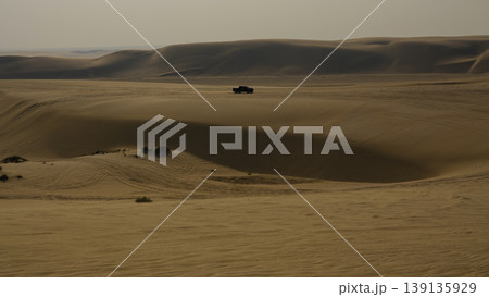 an off road vehicle driving in the desert an off road vehicle driving in the desert 139135929