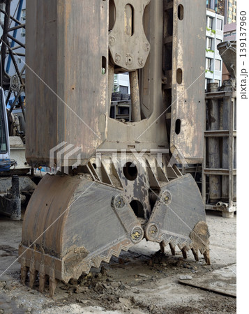 Heavy construction grab bucket on muddy site Heavy construction grab bucket on muddy site 139137960