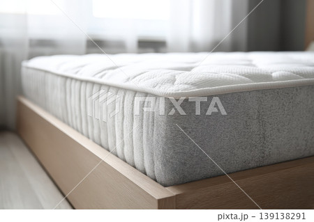 Mattress. Bed with comfortable orthopedic mattress in light room. Quilted white mattress for restful healthy posture sleep. Softness supported by layers inside fabric seal. Memory Foam Core Mattress 139138291