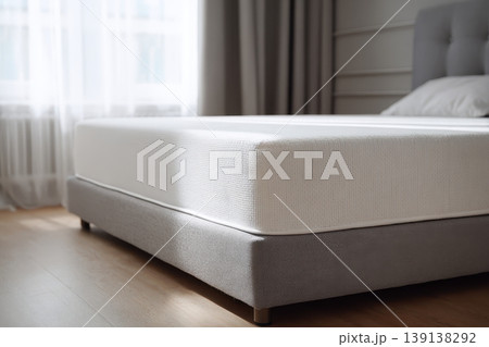 Mattress. Bed with comfortable orthopedic mattress in light room. Quilted white mattress for restful healthy posture sleep. Softness supported by layers inside fabric seal. Memory Foam Core Mattress 139138292