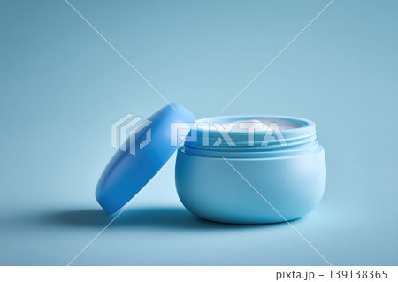 Vaseline pure petroleum jelly. Big white container of cream with copy space for text. Jar with open lid. Blue background. Creamy skin care product. Glossy balm texture. Glossy balm jar skincare Vaseline pure petroleum jelly. Big white container of cream with copy space for text. Jar with open lid. Blue background. Creamy skin care product. Glossy balm texture. Glossy balm jar skincare 139138365