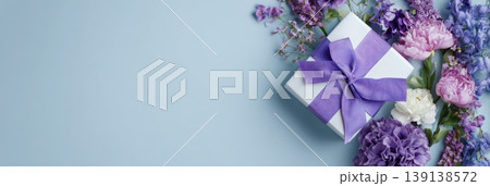 Spring gift. Spring background. Purple Giftbox with flowers on light blue plain color backdrop. Flower pattern banner. Blossom abstract texture. Beautiful Floral wallpaper. Women Day, 8th March 8 card 139138572