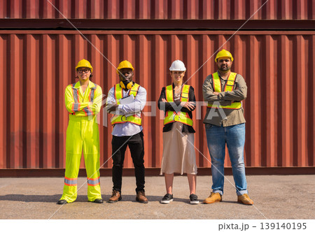 Portrait group of attractive multicultural worker people in yellow vest and helmet standing together at cargo container logistic shipyard. Portrait group of attractive multicultural worker people in yellow vest and helmet standing together at cargo container logistic shipyard. 139140195