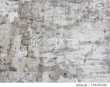Old wall with peeling paint shows layers of color and texture from years of wear Old wall with peeling paint shows layers of color and texture from years of wear 139140382