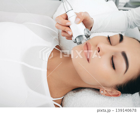 after lpg massage of the face, the woman's face shines with youth and freshness. Anti-aging face contour correction 139140678