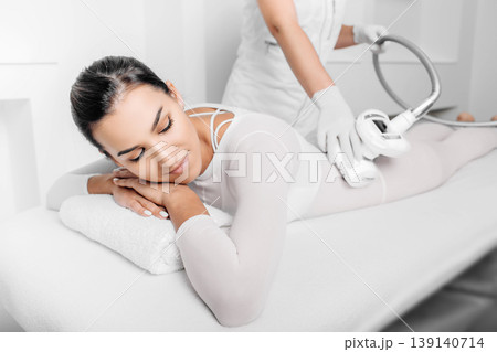 Beautiful woman receiving lpg massage against cellulite Beautiful woman receiving lpg massage against cellulite 139140714