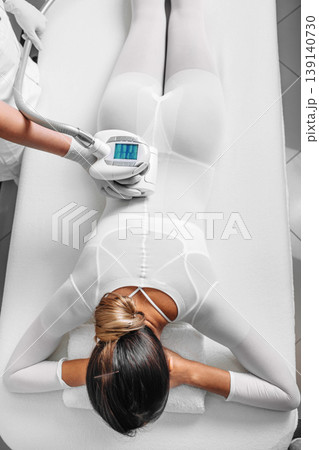 Beautiful woman receiving lpg massage against cellulite Beautiful woman receiving lpg massage against cellulite 139140730