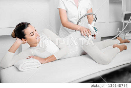 Beautiful woman receiving lpg massage against cellulite Beautiful woman receiving lpg massage against cellulite 139140755
