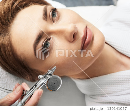 Jet peeling, anti-aging face peel procedure for regenerate skin. Adult woman during jet peeling procedure, close-up 139141057