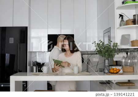 Healthy woman and man together. Couple in kitchen in home for morning. Healthy woman and man together. Couple in kitchen in home for morning. 139141221
