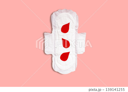 Menstrual pad with red drops on pink background. Menstruation cycle period, woman hygiene and comfort concept Menstrual pad with red drops on pink background. Menstruation cycle period, woman hygiene and comfort concept 139141255