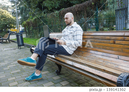 Portrait of man freelancer working remotely online with laptop 139141302